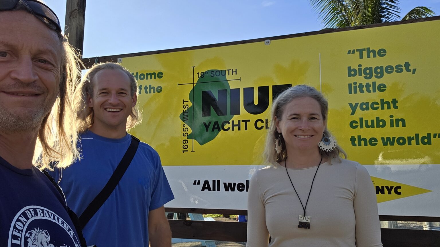 Happy faces in front of NYC, the Niue Yacht Club, where no one owns a boat and no one knows how to sail